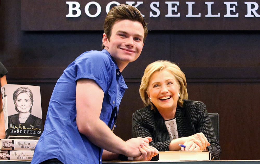 Television actor and Glee star, Chris Colfer, left, poses for a photo with former Secretary of State Hillary Rodham Clinton, a book signing event at Barnes & Noble at The Grove in Los Angeles.