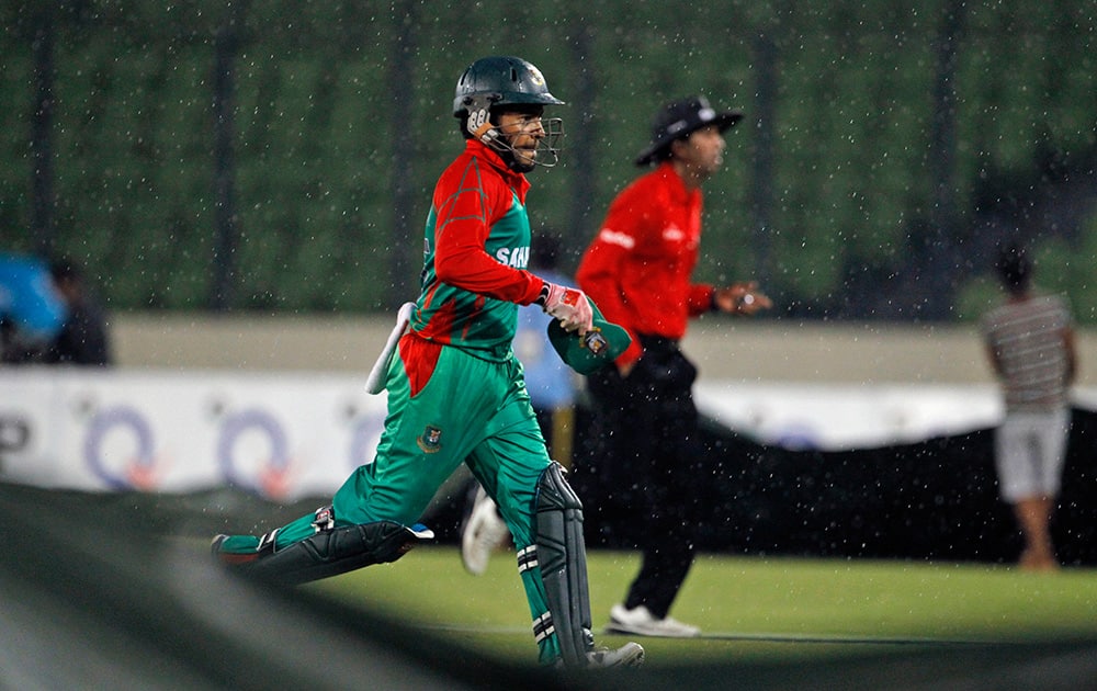 Bangladesh`s captain Mushfiqur Rahim runs back to the pavilion when play was halted due to rain during the third one-day International cricket match against India in Dhaka, Bangladesh.