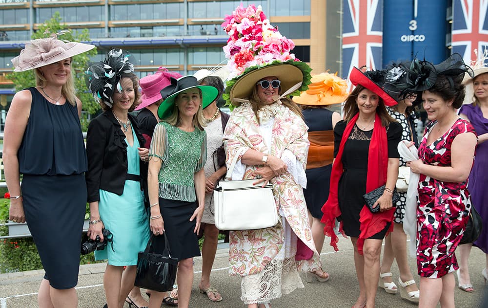 Paula Iachetti, centre, poses with a group of women for photographers on the third day of the Royal Ascot horse racing meeting, which is traditionally known as Ladies Day, at Ascot, England.