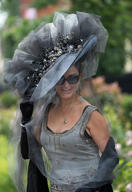 Dena Dobie wears a large ornate hat on the third day of the Royal Ascot horse racing meeting, which is traditionally known as Ladies Day, at Ascot, England.