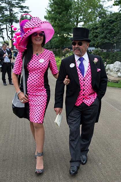 Brian Mann and Rachel Johnson wear matching black spots on pink on the third day of the Royal Ascot horse racing meeting, which is traditionally known as Ladies Day, at Ascot, England.