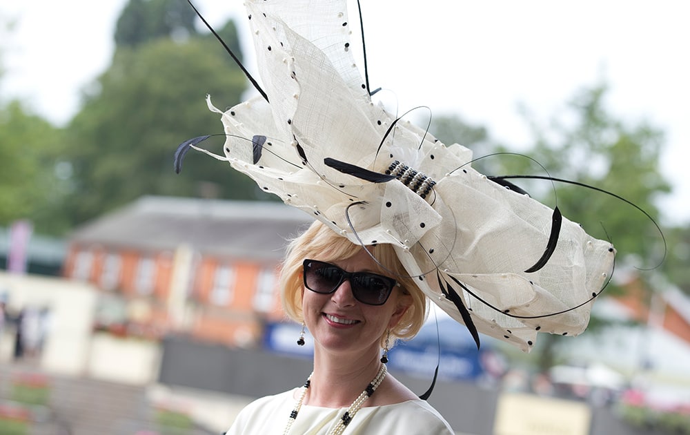 Beverley Midgley-McDonald wears an ornate hat as she walks near the parade ring on the third day of the Royal Ascot horse racing meeting, which is traditionally known as Ladies Day, at Ascot, England.