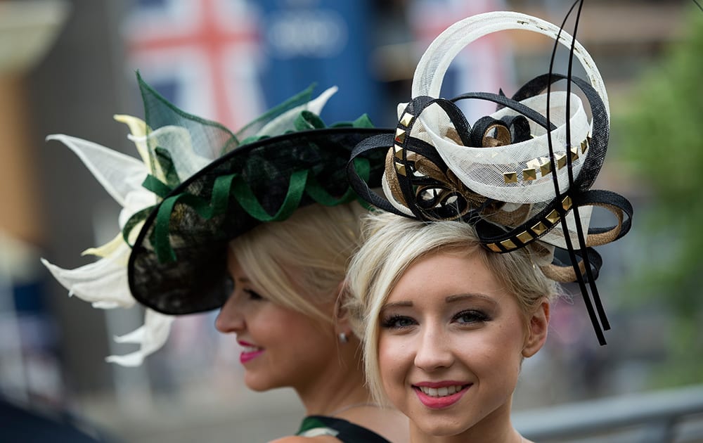 Sharon Teague, left and her daughter Ellie wear ornate hats as they pose for photographers on the third day of the Royal Ascot horse racing meeting, which is traditionally known as Ladies Day, at Ascot.