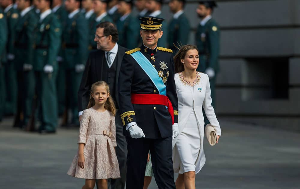 Spain’s newly crowned King Felipe VI, second right, Spanish Queen Letizia, right, and Spanish Princess Leonor, left, arrive at the Parliament in Madrid, Spain.