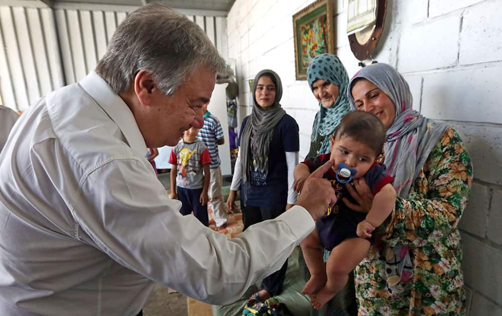 United Nations High Commissioner for Refugees (UNHCR) Antonio Guterres greets a Syrian child during his visit to Khaldeh, south of Beirut, Lebanon.