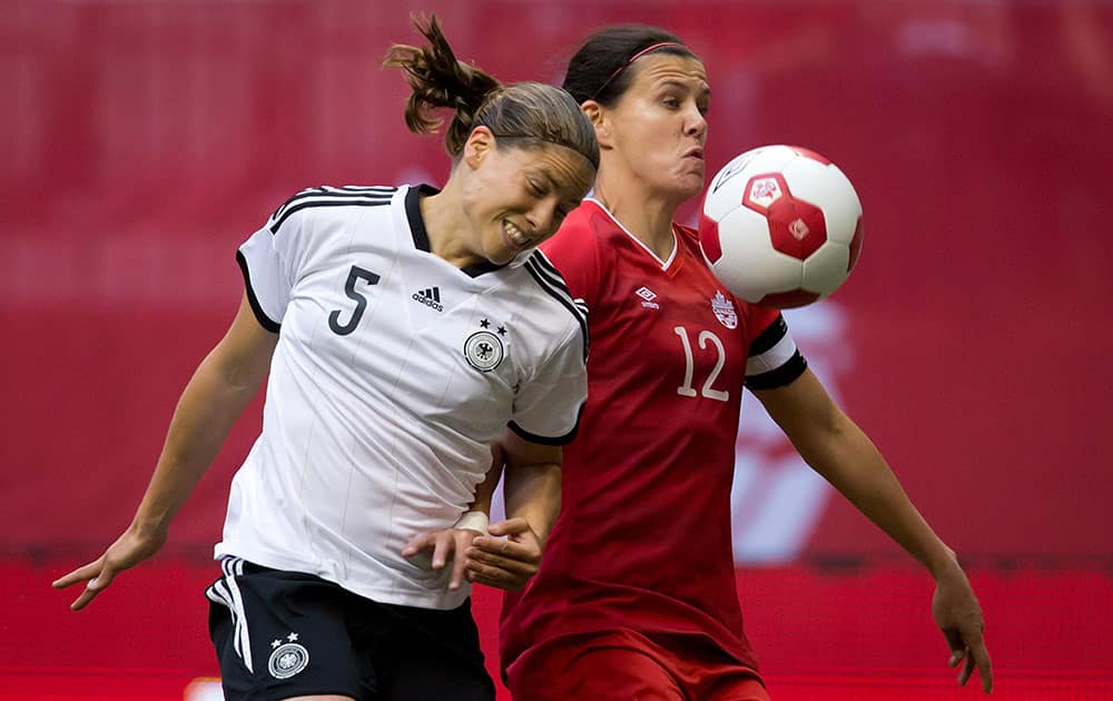 Germany`s Annike Krahn, left, and Canada`s Christine Sinclair vie for the ball during the first half of an international women`s soccer game in Vancouver, British Columbia.