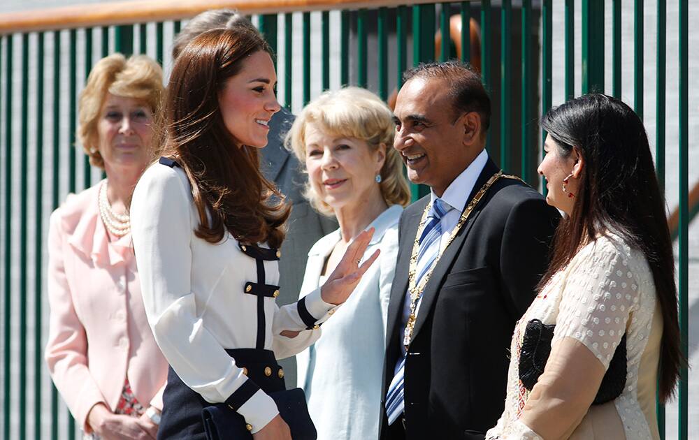 Britain`s Kate, Duchess of Cambridge, foreground left, meets officials as she arrives for a visit at Bletchley Park, near Milton Keynes, England.