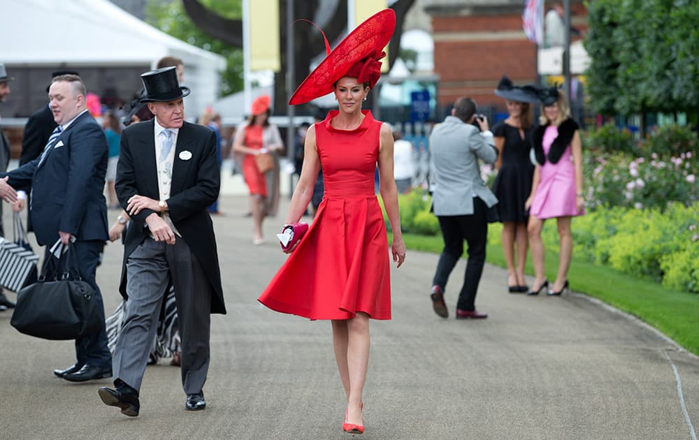 Milnda Strudwick wears a large red ornate hat on the second day of the Royal Ascot horse racing meeting at Ascot, England.