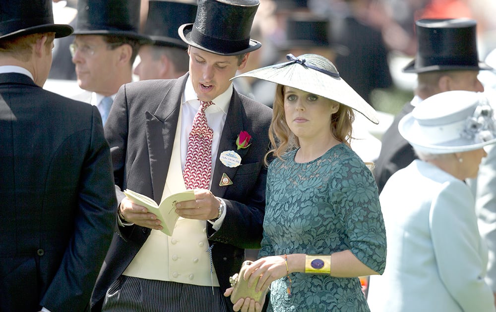 Princess Beatrice, right, waits for the first race in the parade ring on the first day of the Royal Ascot horse racing meeting at Ascot, England.