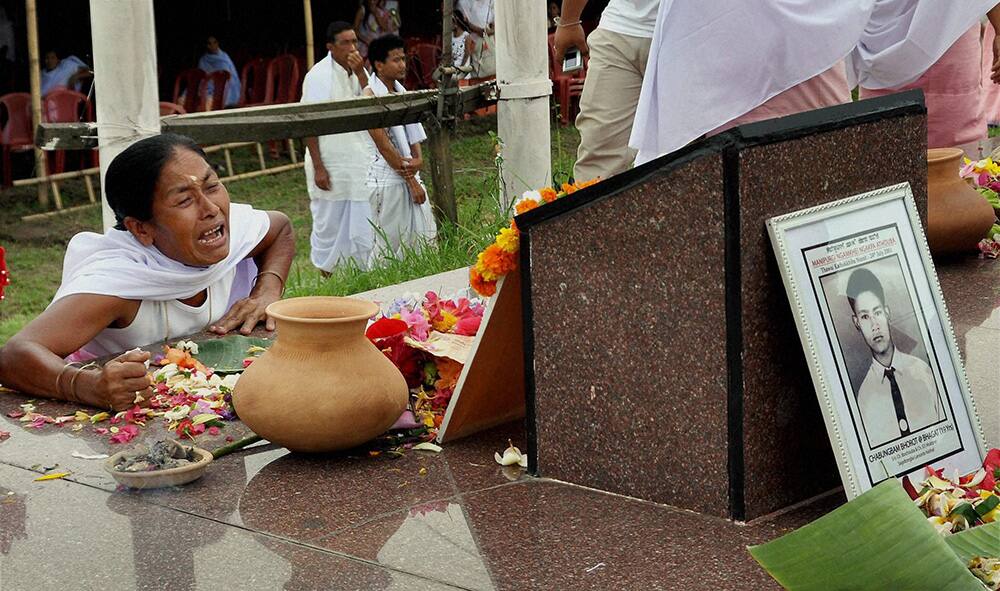 A woman cries as she pays tribute at the martyrs` memorial on 13th anniversary of Great June Uprising Day in Kekrupat, Imphal.