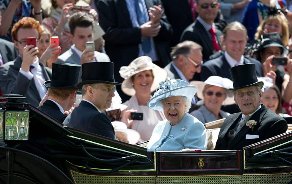 Britain`s Queen Elizabeth II, centre, with Prince Philip, right, Prince Andrew, second right and Prince Harry, arrive by carriage, on the first day of the Royal Ascot horse racing meeting at Ascot, England.