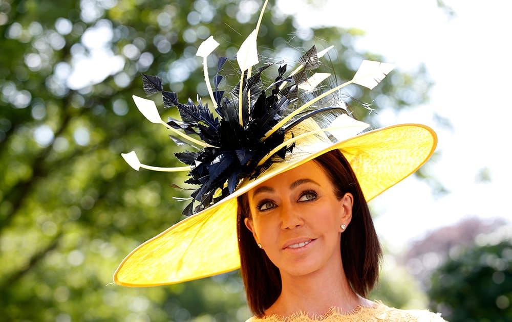 A race goer wears an ornate hat on the first day of the Royal Ascot horse racing meeting in Ascot, England.