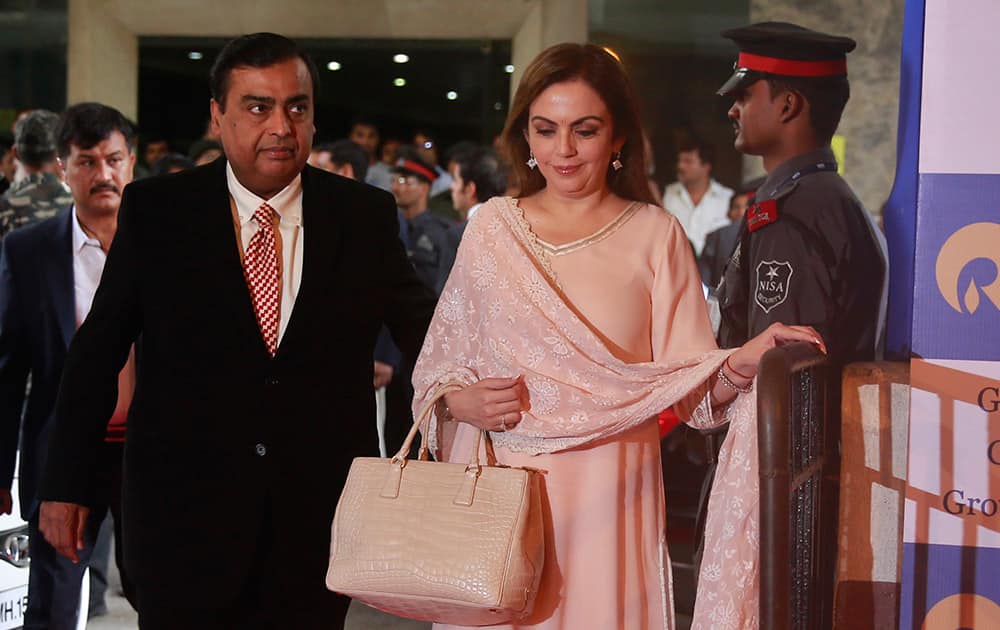 India`s largest private sector company, Reliance Industries chairman Mukesh Ambani and his wife Nita Ambani arrive for the company`s annual general meeting in Mumbai.