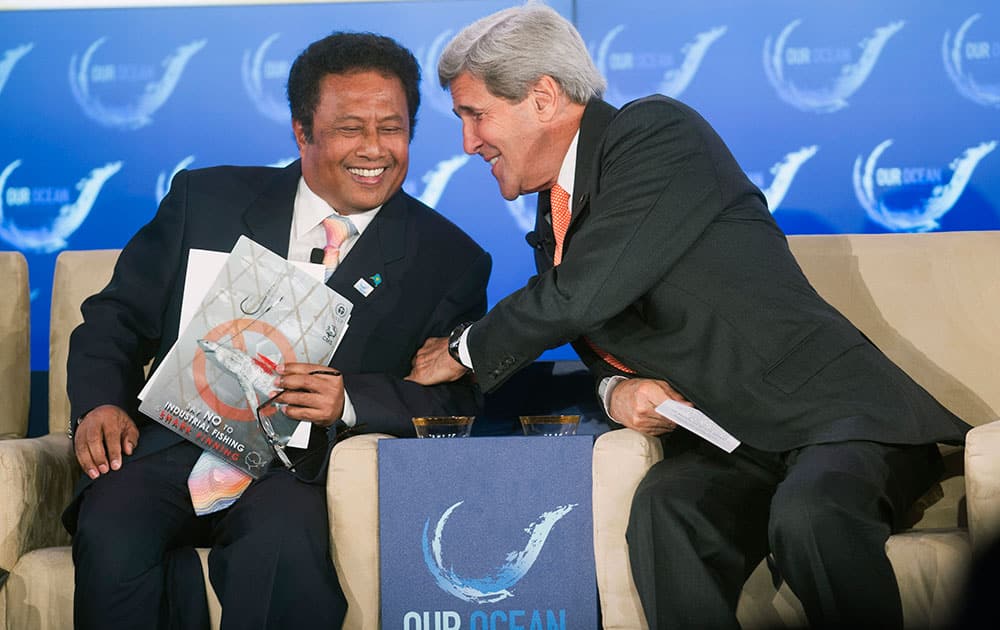 Secretary of State John Kerry talks with Republic of Palau President Tommy Remengesau as they participate in the second day of the State Department`s `Our Ocean` conference at the State Department in Washington.