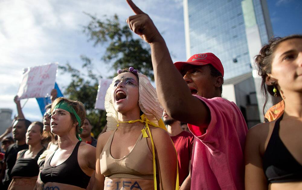 People shout slogans against riot police during an anti-World Cup soccer protest in Belo Horizonte, Brazil.