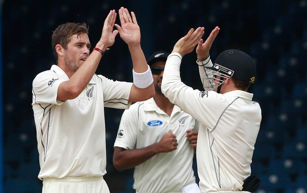 New Zealand`s bowler Tim Southee celebrates with wicket keeper BJ Watling after taking the wicket of West Indies` Sulieman Benn, who was bowled for 4 runs during the second day of their second cricket Test match in Port of Spain, Trinidad.