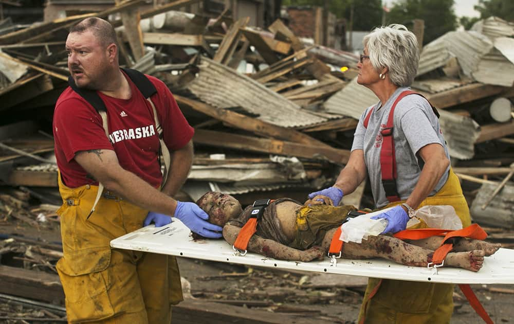 Rescue personnel tend to a young tornado victim in Pilger, Neb. A hospital spokeswoman says at least one person is dead and at least 16 more are in critical condition after two massive tornadoes swept through northeast Nebraska. 