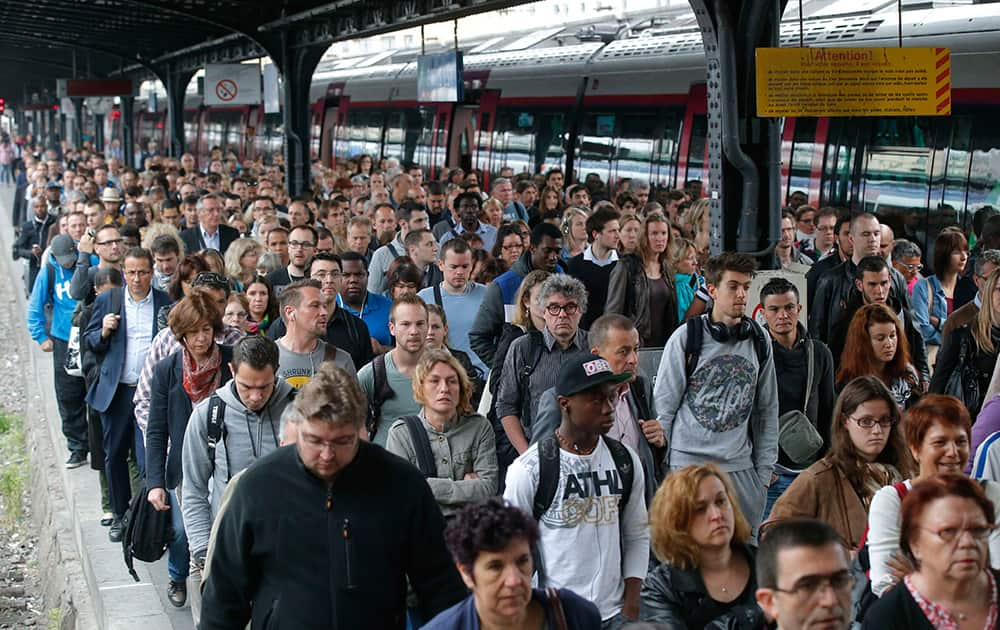 Commuters arrive at the Gare de l`Est train station by one of a few trains available today in Paris as French rail workers are on strike to protest a reorganization of the national rail and train companies.