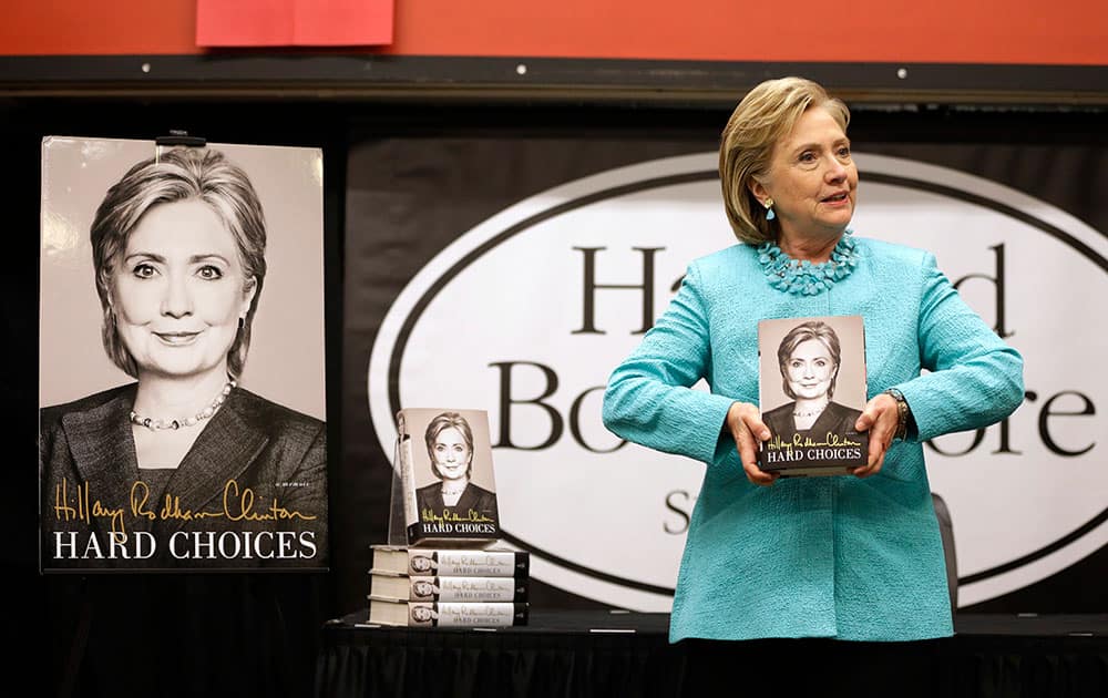 HiIlary Rodham Clinton holds a copy of her new book `Hard Choices,` at the start of a book signing at Harvard Book Store, in Cambridge, Mass. 