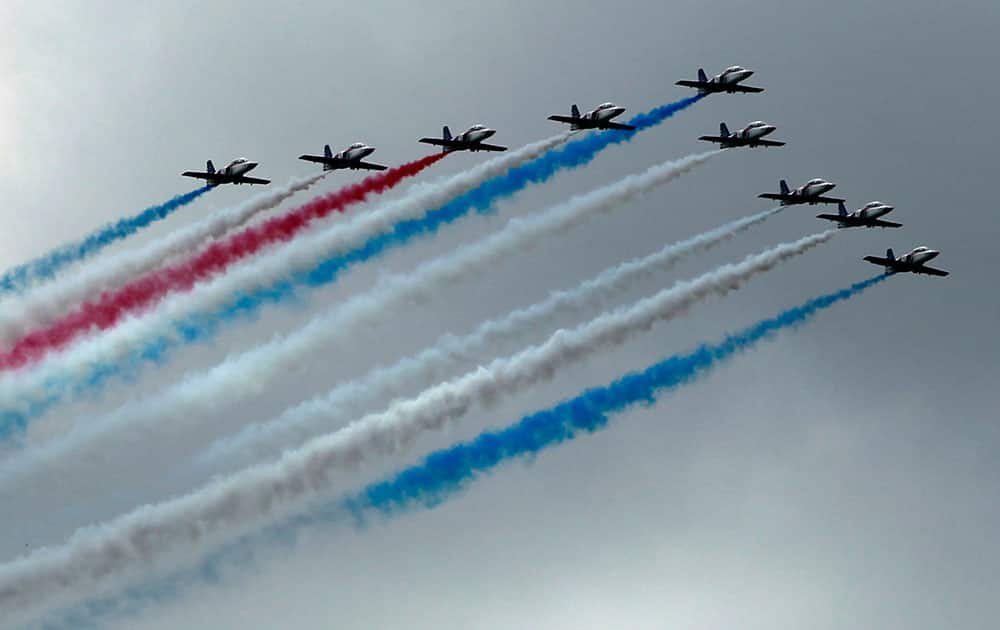 AT-3 jets fly in formation with colored smoke during a ceremony marking the 90th anniversary of Taiwan`s military academy in Kaohsiung.