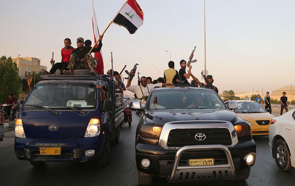 Shiite tribal fighters raise their weapons and chant slogans against the al-Qaida-inspired Islamic State of Iraq and the Levant (ISIL) in Basra, Iraq`s second-largest city, 340 miles (550 kilometers) southeast of Baghdad, Iraq.