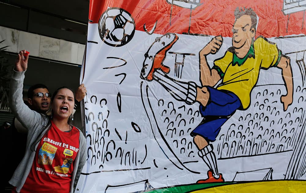 Demonstrators shout slogans during a protest against the World Cup, in Brasilia.