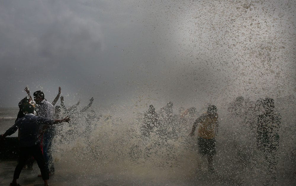 Indians enjoy high tide waves on the Arabian Sea coast in Mumbai, India. Authorities have warned people against going near the Sea as tidal waves measuring 4.5 meters (15 feet) have been hitting the shore.