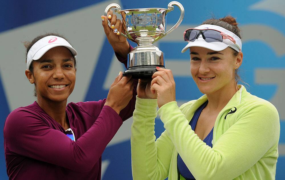 USA`s Raquel Kops-Jones, left, and Abigail Spears celebrate with trophy after winning their Doubles Final against Australia`s Ashleigh Barty and Casey Dellacqua during the Aegon Classic at Edgbaston Priory Club in Birmingham, England.