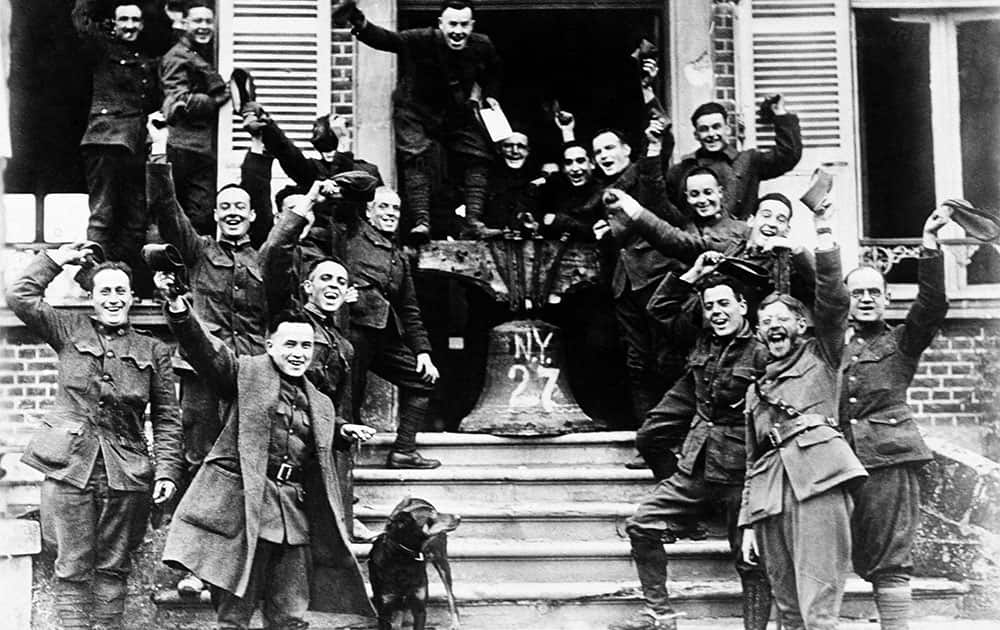 NINETY SEVEN OF ONE HUNDRED PHOTOS WORLD WAR ONE CENTENARY TIMELINE - In this Nov. 1918 file photo, American soldiers from New York, who served on the frontline in Cambria, France, rig up a Liberty Bell to celebrate the signing of the Armistice to end World War One.