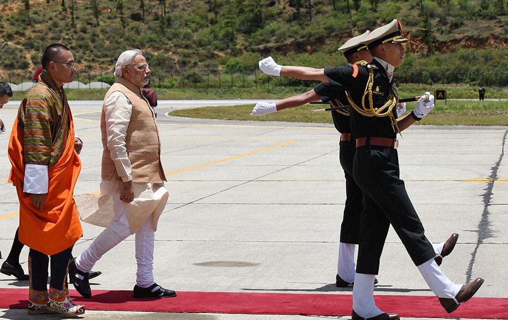 PRIME MINISTER NARENDRA MODI DURING A CEREMONIAL WELCOMED ON HIS ARRIVAL AT THE PARO INTERNATIONAL AIRPORT IN BHUTAN.