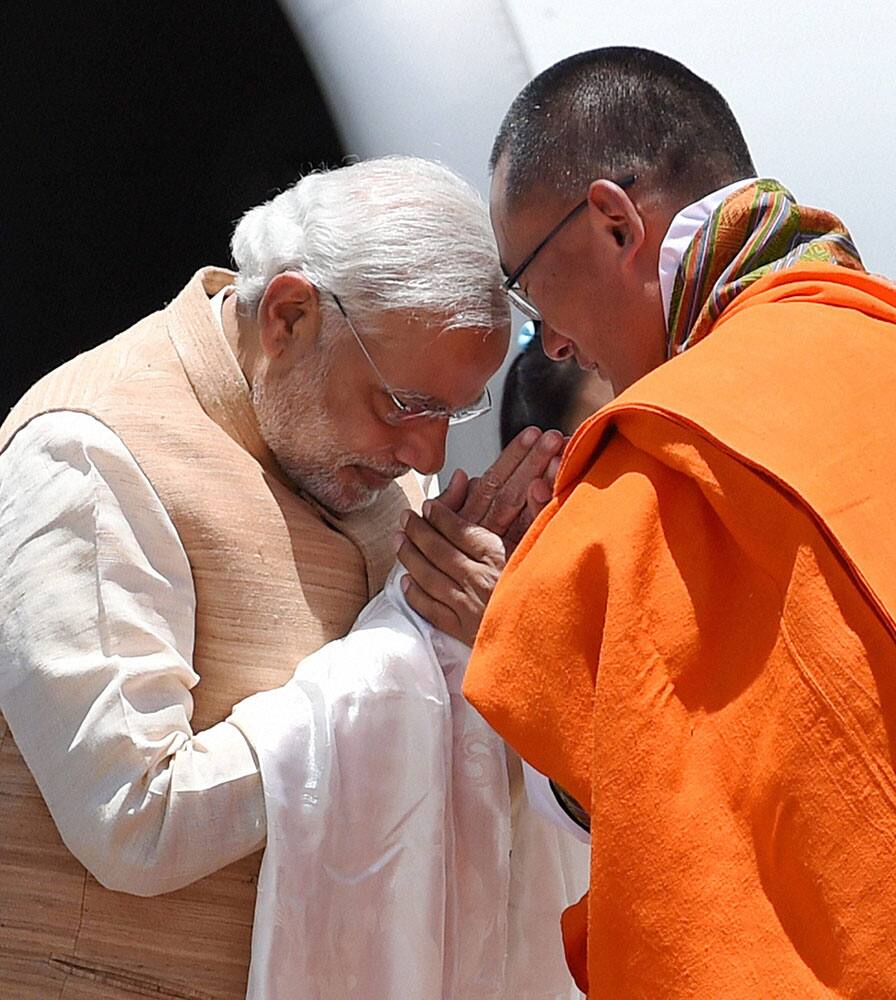 Prime Minister Narendra Modi being received by his Bhutanese counterpart Tshering Tobgay on his arrival at the Paro International Airport in Bhutan.