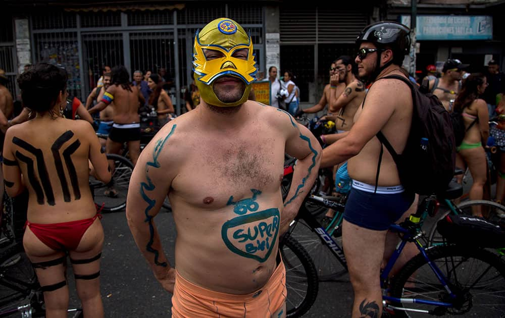 A cyclist wearing a Lucha Libre wrestling mask takes a break during a protest Caracas, Venezuela.