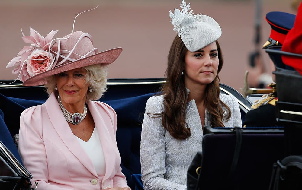 Britain`s Camilla, Duchess of Cornwall, left, and Kate, Duchess of Cambridge, right, leave in a horse drawn carriage to attend the Trooping the Colour parade, in central London.