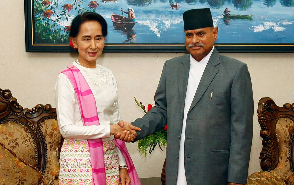 Myanmar opposition leader Aung San Suu Kyi, left, and Nepal’s President Ram Baran Yadav pose for photos during a meeting at the president`s residence in Katmandu, Nepal.