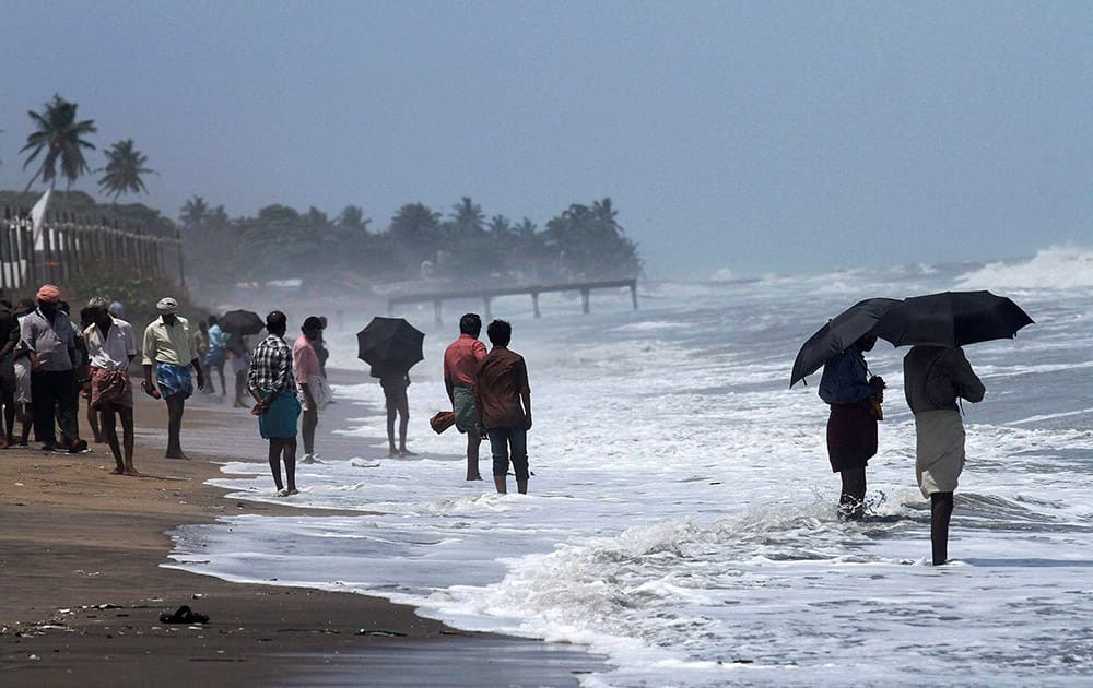 People enjoying high tide at Kozhikode beach.