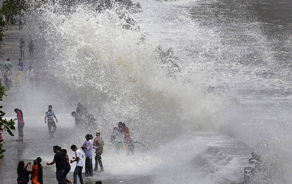 Visitors enjoy high tide at Marine Drive in Mumbai.