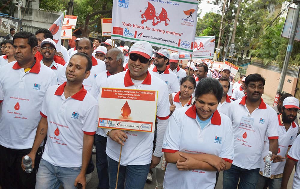 Former crickter VVS Laxman and Executive Director of Apollo Hospitals Group, Sangita Reddy (R) participate in an awareness walk on the occasion of `World Blood Donors Day` in Hyderabad.