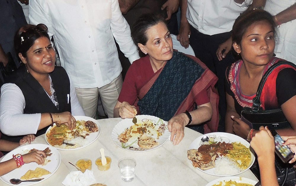 Congress President Sonia Gandhi having dinner with party workers after a party meeting in her costituency in Raebareli.