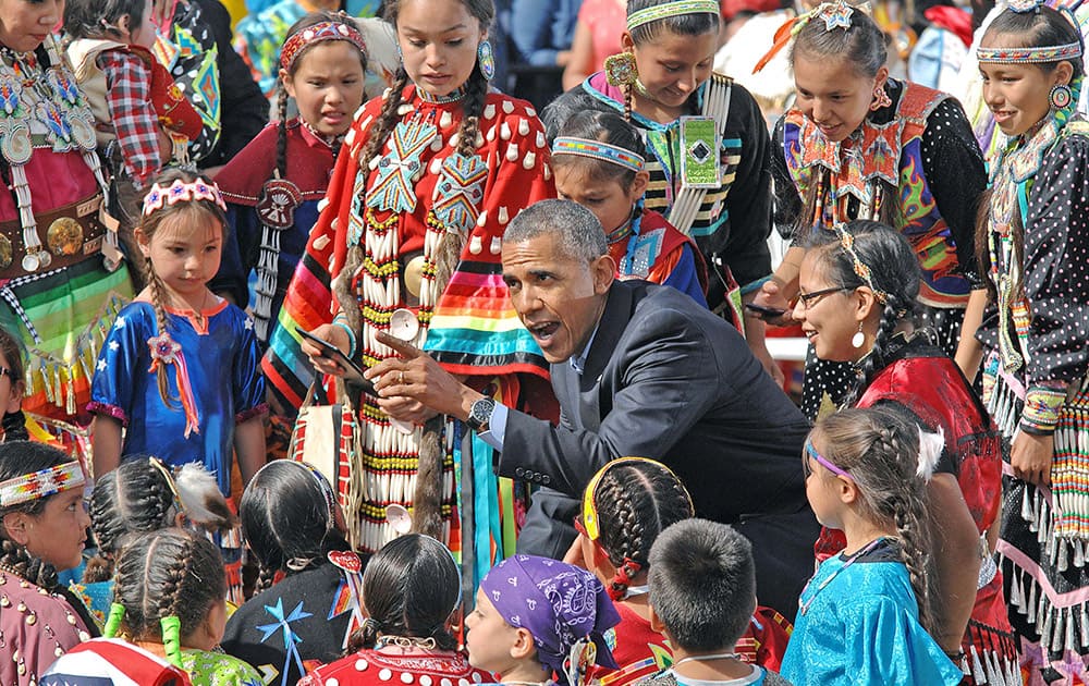 President Barack Obama visits with Native American youngsters during his visit to Cannon Ball, N.D.