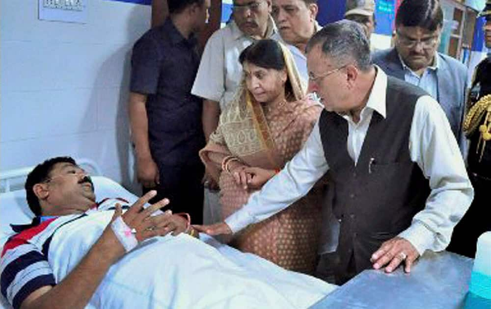 Chhatisgarh Governor Shekhar Dutt visits an injured victim of the poisonous gas leakage at Bhilai Steel Plant, at a hospital in Bhilai. An explosion inside a pipe at the plant resulted in the release of a poisonous gas on Thursday.