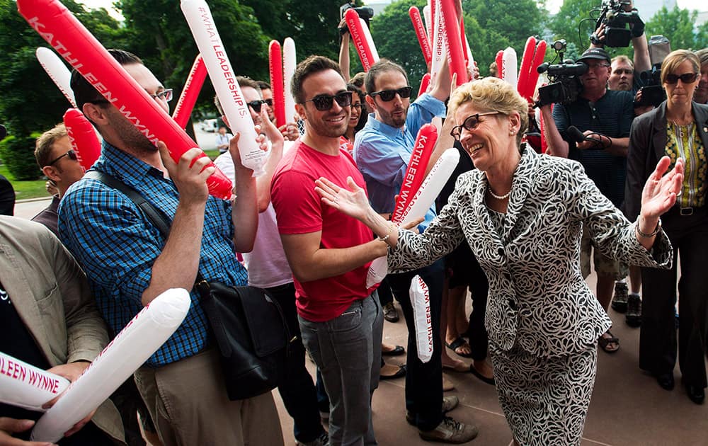 Ontario Premier Kathleen Wynne greets supporters and staff after winning a majority government at Queen`s Park in Toronto. Wynne became the first woman elected Premier of Ontario.