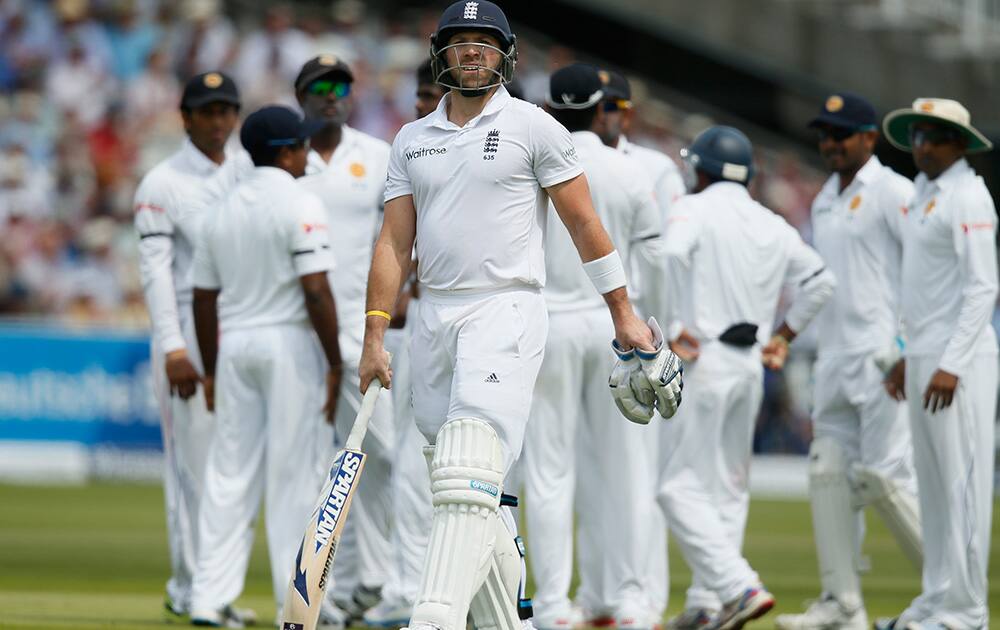 England`s Matt Prior walks from the pitch after being given out caught by Sri Lanka`s Kaushal Silva on the second day of the first test cricket match between England and Sri Lanka at Lord`s cricket ground in London.