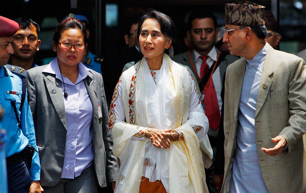 Myanmar’s pro-democracy leader Aung San Suu Kyi arrives at Nepalese Tribhuwan International Airport in Katmandu, Nepal. Suu Kyi arrived in Nepal Friday to attend a democracy conference, meet top political leaders and visit Buddhist pilgrimage sites.