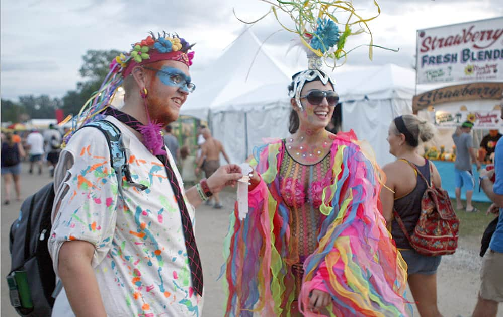 Nicholas Manes and Valerie Biles are dressed in costume trying to be selected as Mr. and Ms. Bonnaroo at the Bonnaroo Music & Arts Festival, in Manchester, Tenn.