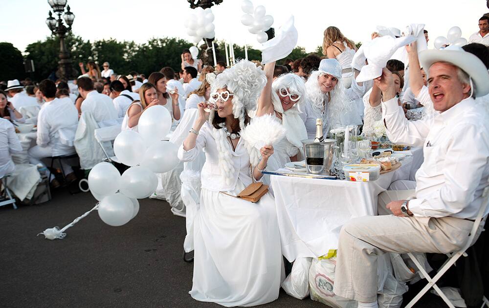 Participants dressed in white take part in Diner en Blanc, or White Dinner, at the Invalides gardens, in Paris