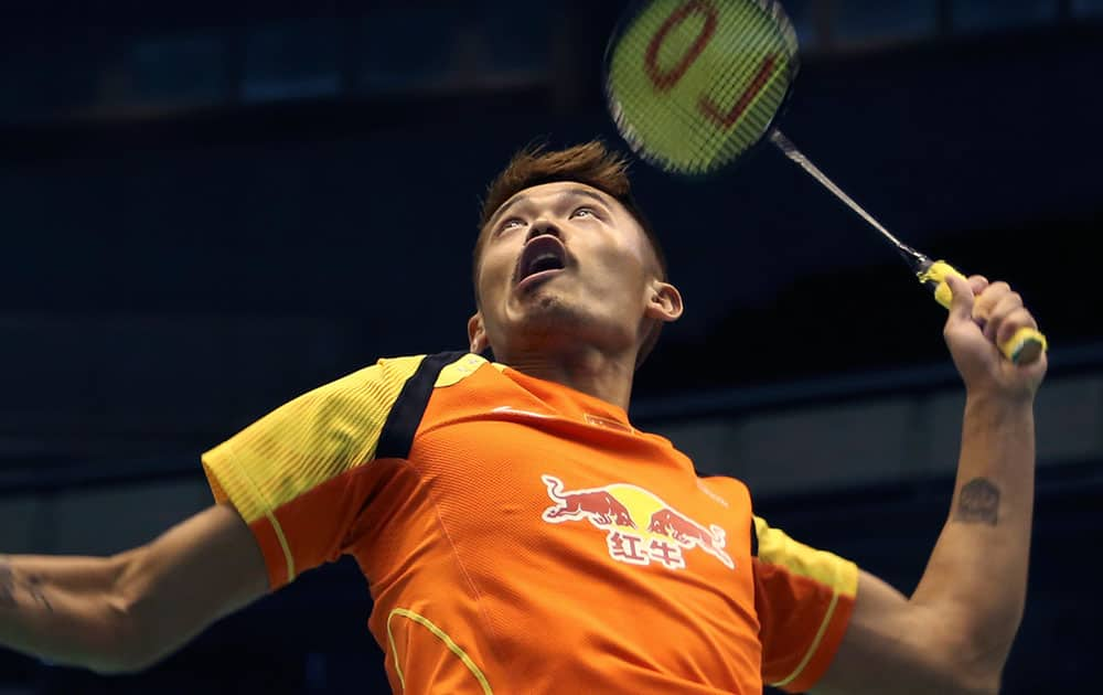 Lin Dan of China plays against Chong Wei Feng of Malaysia during the second round of the Japan Open Badminton Championship.