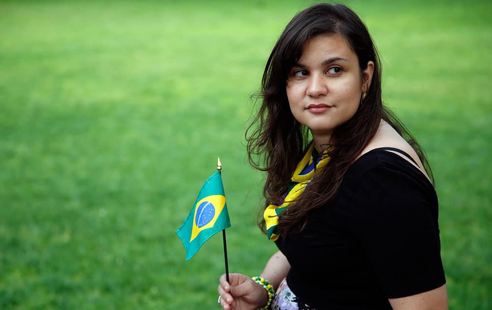 Renata Teodoro poses near the Statehouse in Boston. As all eyes turn to Brazil for the World Cup, the Brazilian influence in the United States is also gaining attention. `It was the first time I ever laugh-cried,` Renata Teodoro, 22, says of her December trip to Brazil. 