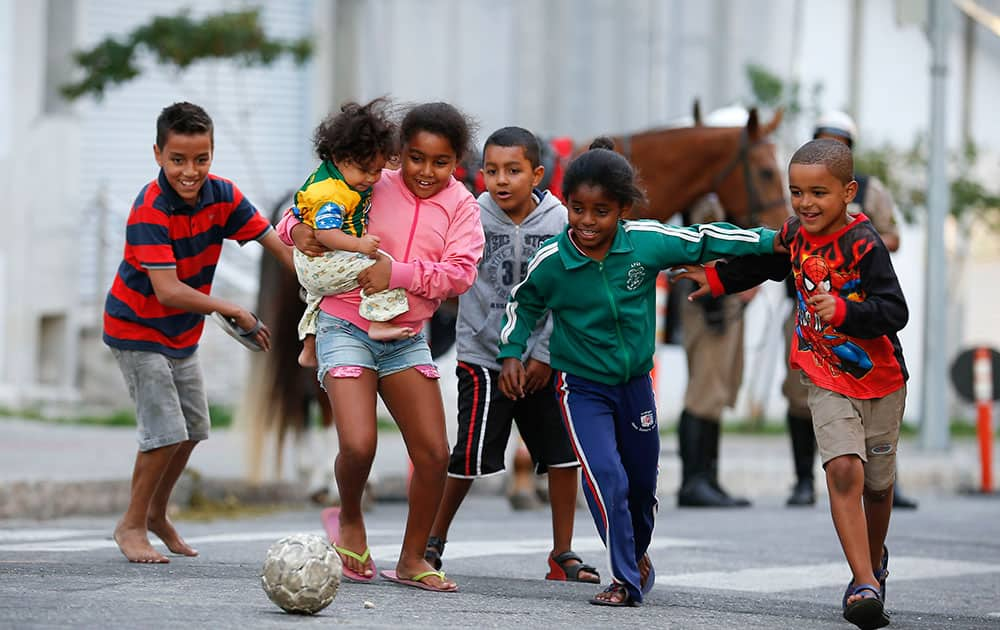 Children kick around a soccer ball outside the Independencia Stadium in Belo Horizonte, Brazil.