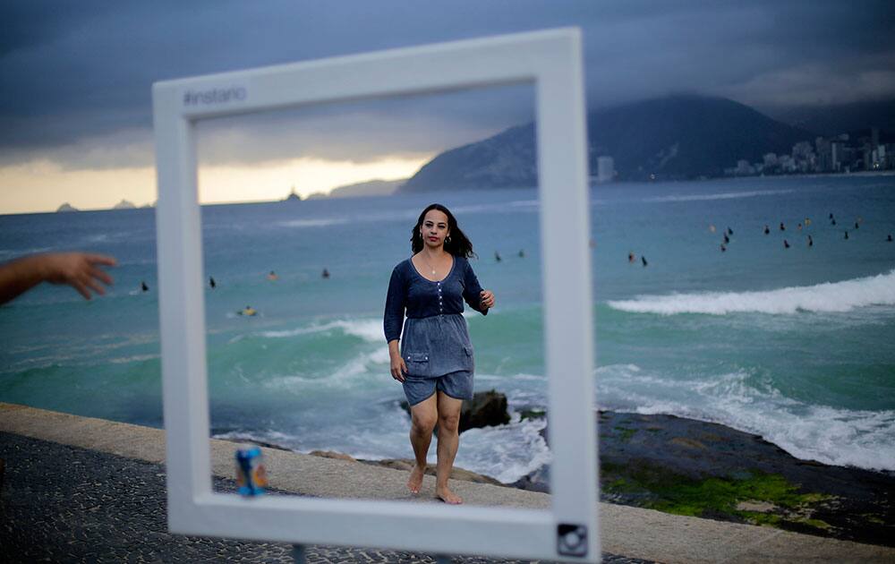 Tourists pose for photos in front of Brazil`s famous Ipanema beach, in Rio de Janeiro, Brazil. 