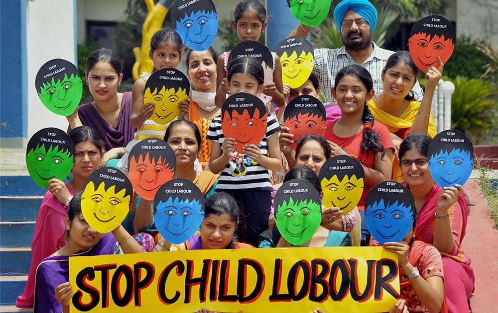 Teachers and students taking part in an awareness program against child labour on the eve of World Day Against Child Labour at a school in Patiala.